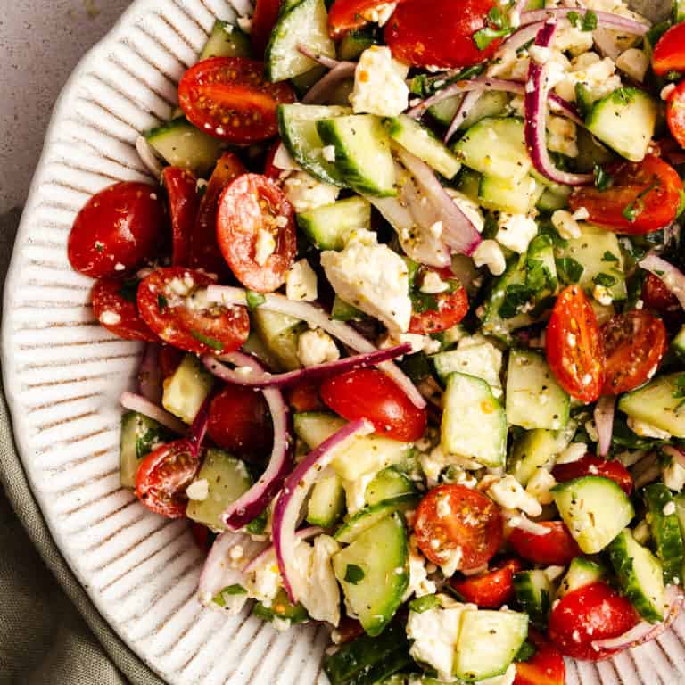 Serving platter filled with cucumber feta salad.