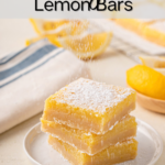 Powdered sugar being dusted over three stacked lemon bars on a white plate. Text overlay includes recipe name.