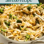 Spoon about to scoop up chicken and broccoli alfredo out of a skillet. Text overlay includes recipe name.