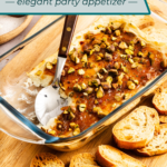 Spoon in a baking dish of baked goat cheese dip, surrounded by toasted baguette slices. Text overlay includes recipe name.