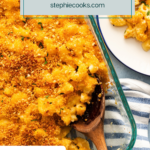 Overhead view of a wooden spoon in the corner of a baking dish of smoked gouda mac and cheese. Text overlay includes recipe name.