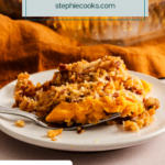 White plate holding a serving of sweet potato casserole with pecan topping. Text overlay includes recipe name.
