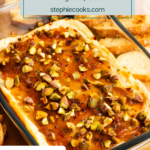 baked goat cheese dip on a wooden board next to toasted baguette slices. Text overlay includes recipe name.