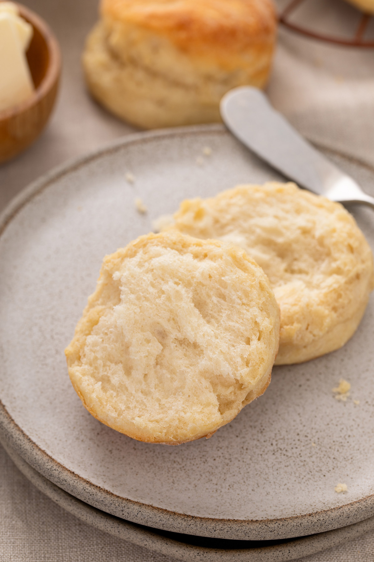 Angel biscuit cut in half on a plate.