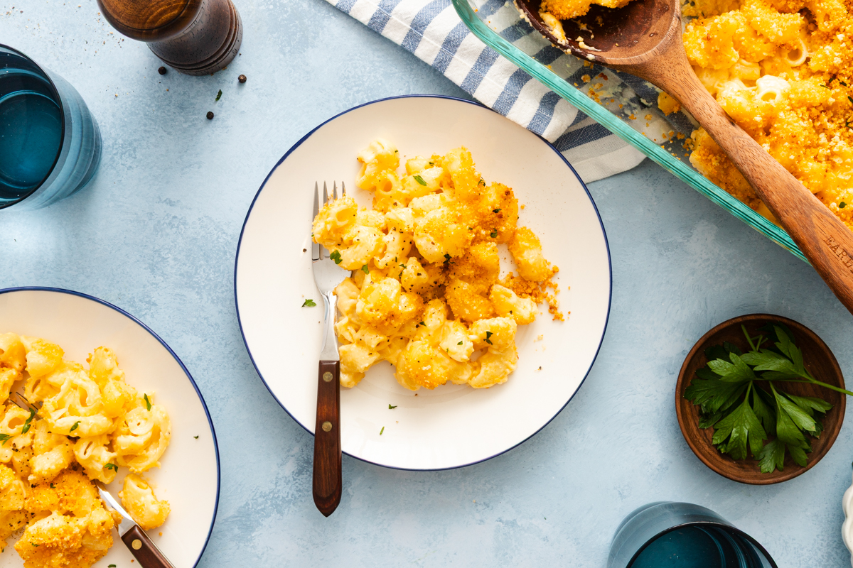 Overhead view of a serving of smoked gouda mac and cheese on a white plate.