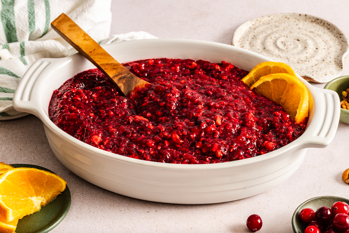 Serving spoon in a large dish of cranberry jello salad.