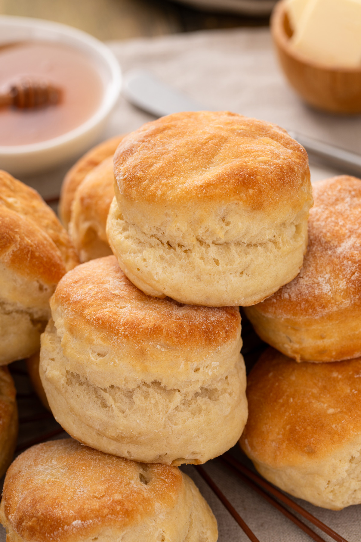 Angel biscuits stacked on a wire rack for serving.