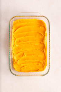 Creamy sweet potato casserole filling spread in a casserole dish.