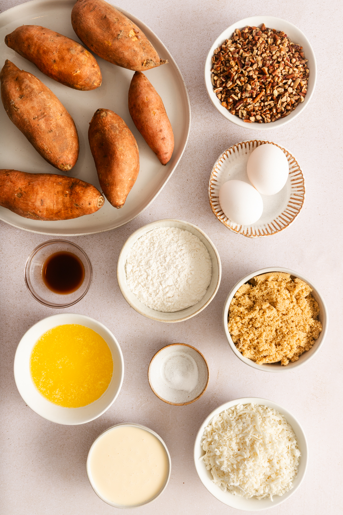 Ingredients for sweet potato casserole with pecan topping arranged on a countertop.